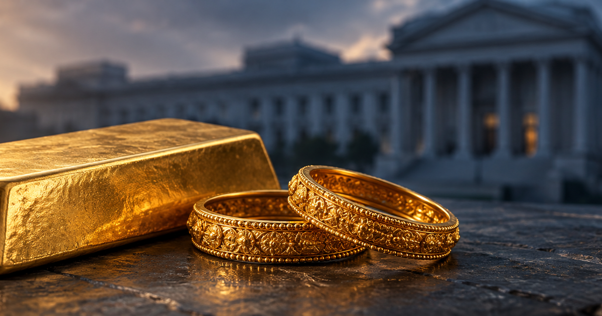 A warmly lit bullion bar beside understated Indian gold bangles on charcoal stone, with a distant generic institutional silhouette in cool shadow.